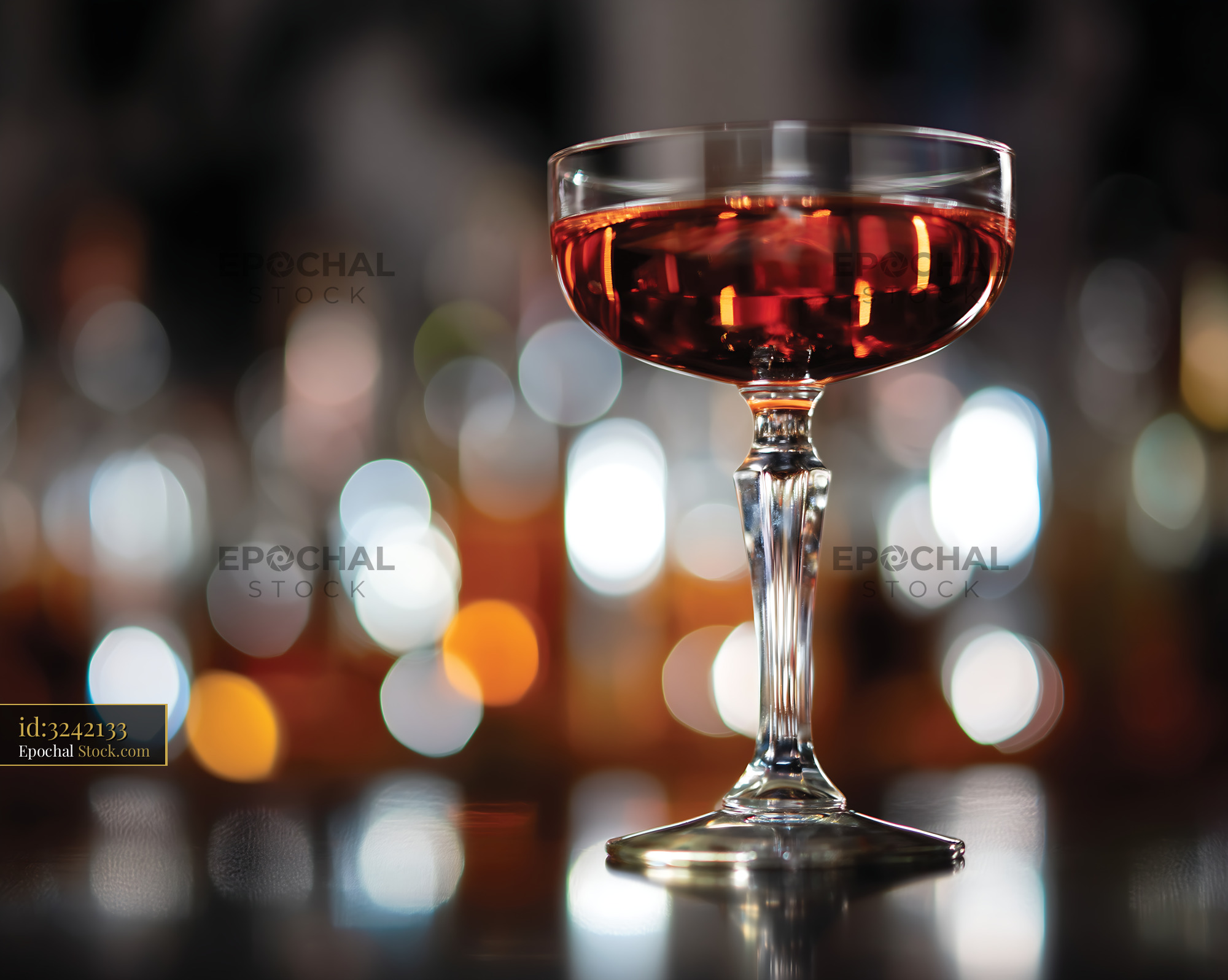 Red Cocktail in Elegant Coupe Glass Bar - stock photo