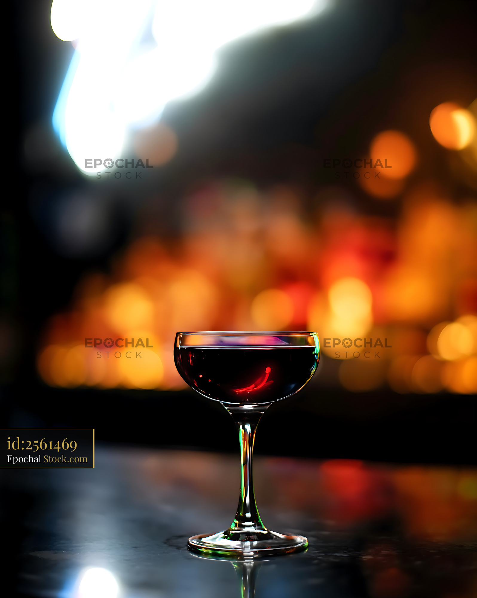 Red Wine Coupe Glass Against City Lights - stock photo