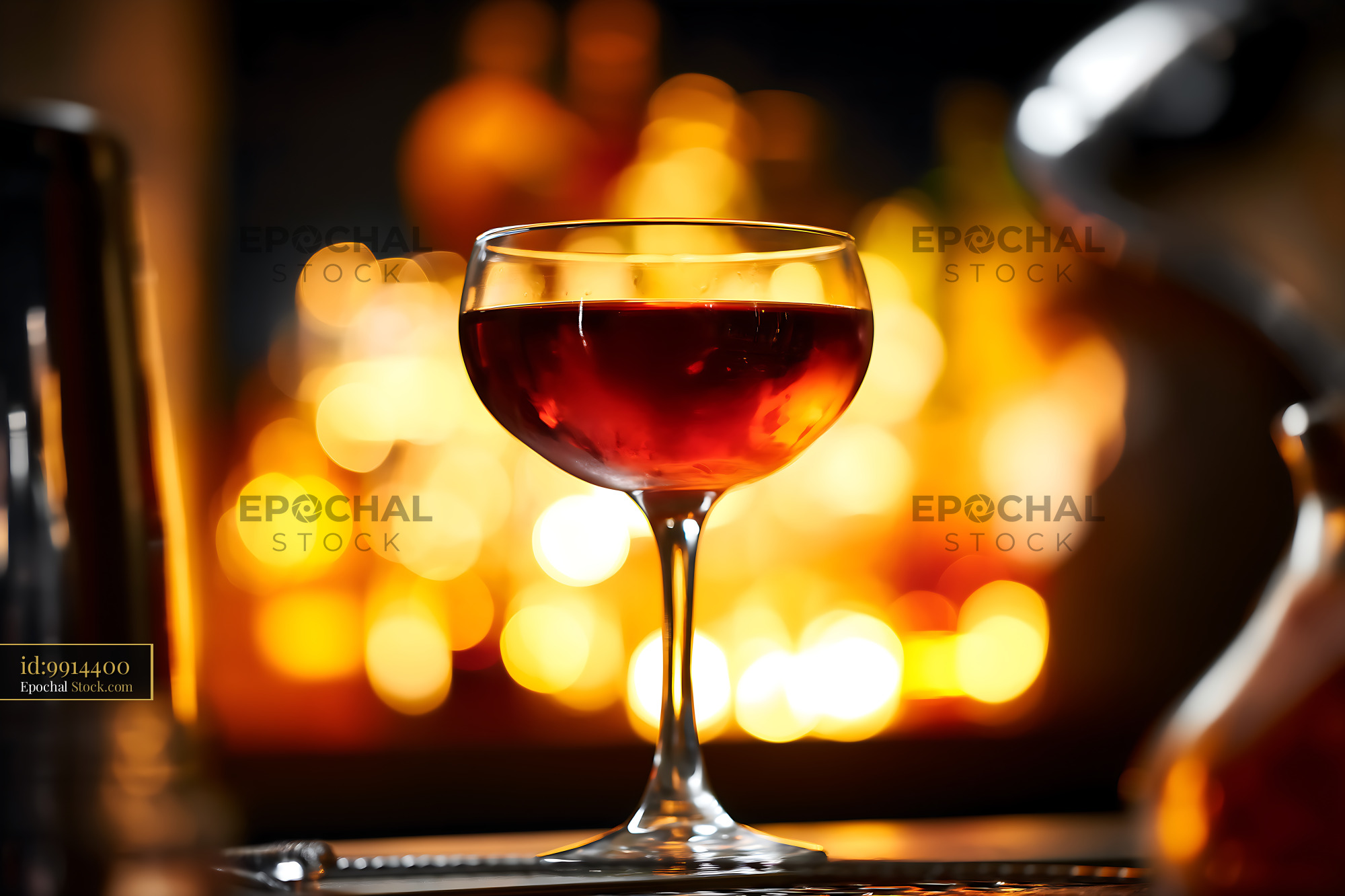 Bushwick Cocktail in Coupe Glass with Warm Bokeh - stock photo