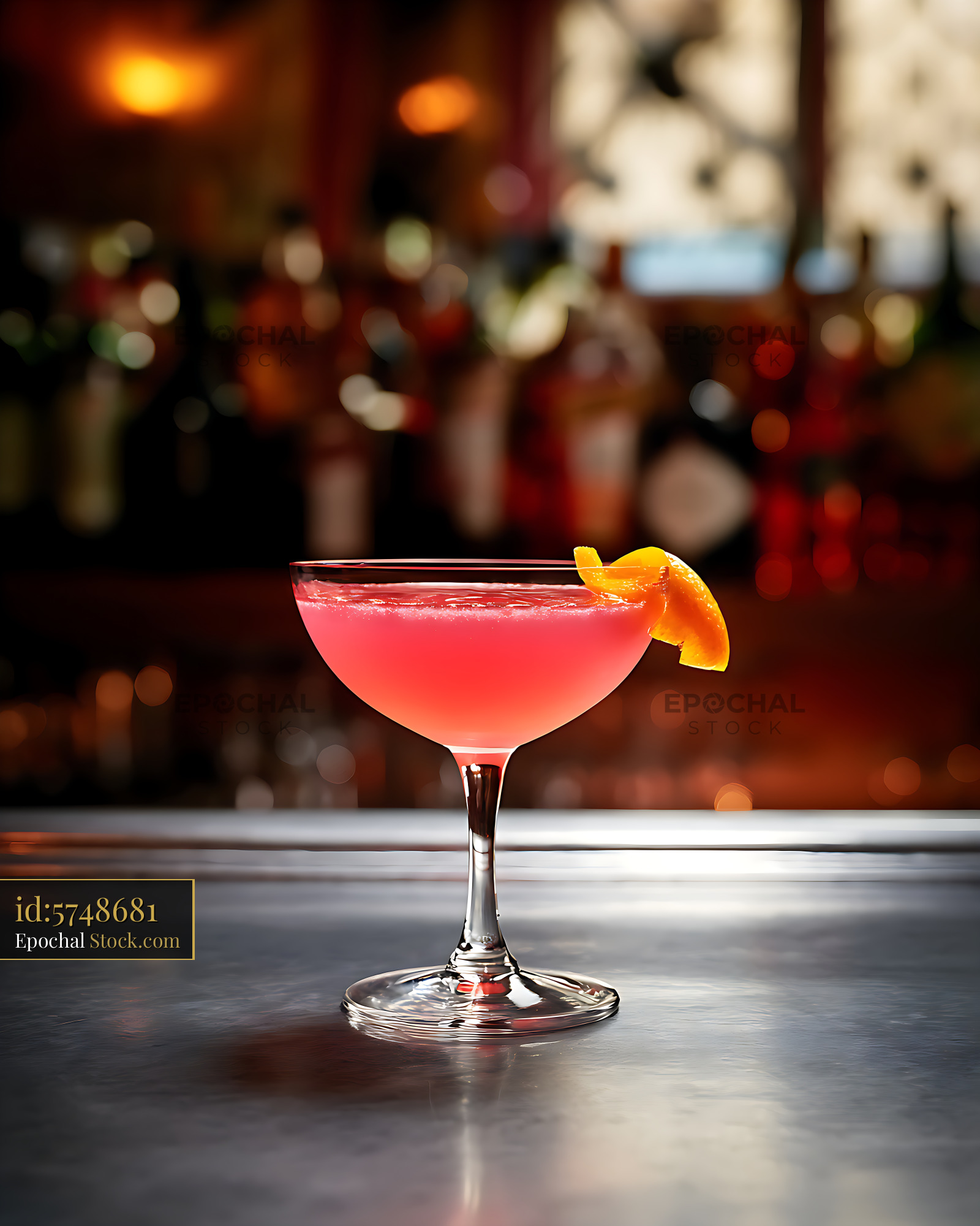 Coral Cocktail with Citrus Garnish at Bar Counter - stock photo