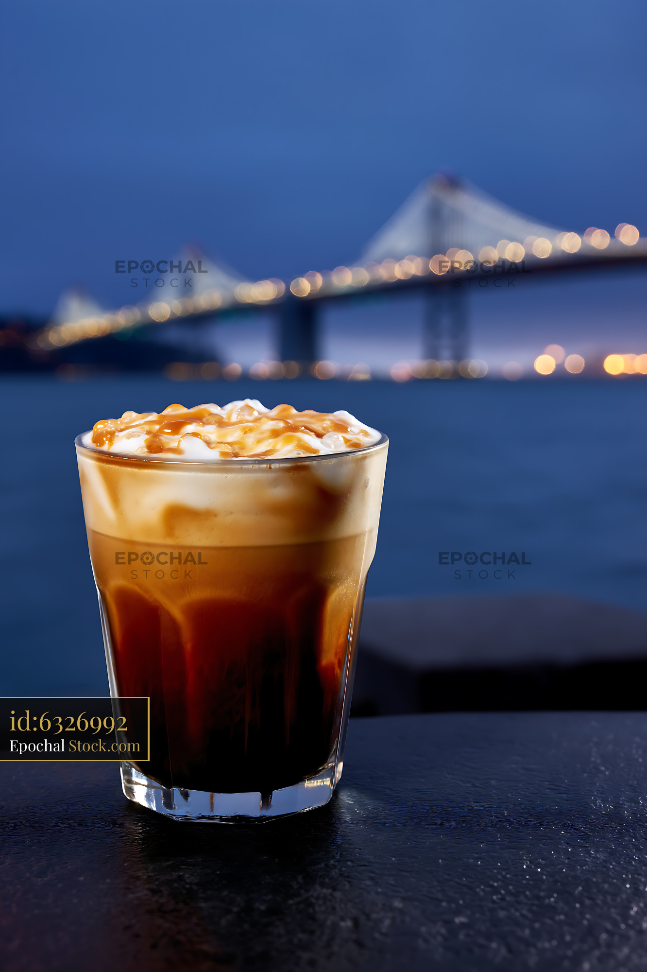 Nitro Caramel Coffee at Dusk by Bridge - stock photo