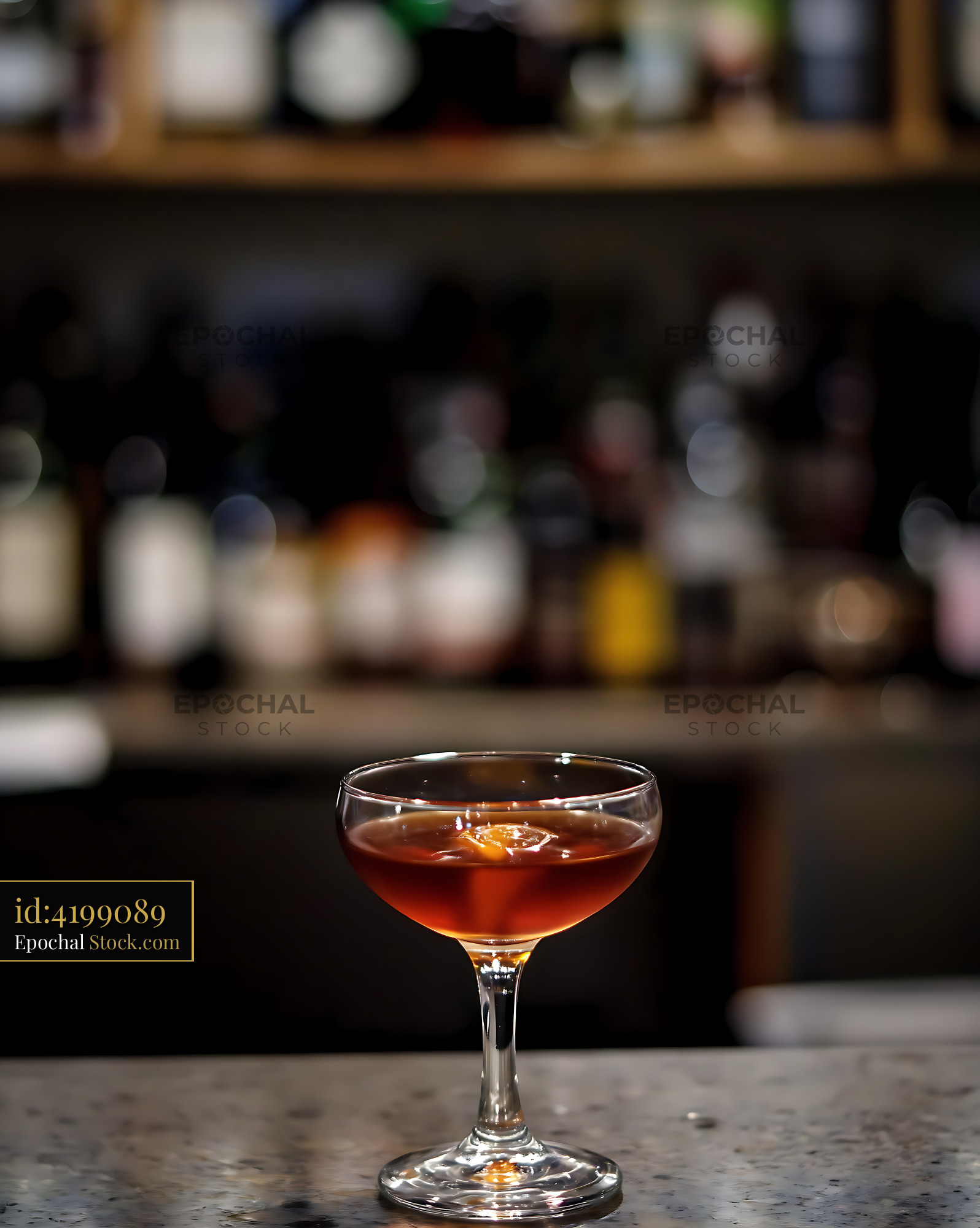 Classic Cocktail in Coupe Glass at Bar Counter - stock photo