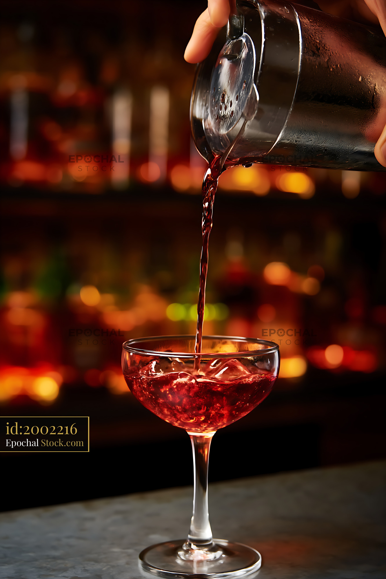 Bushwick Cocktail Pouring into Coupe Glass - stock photo