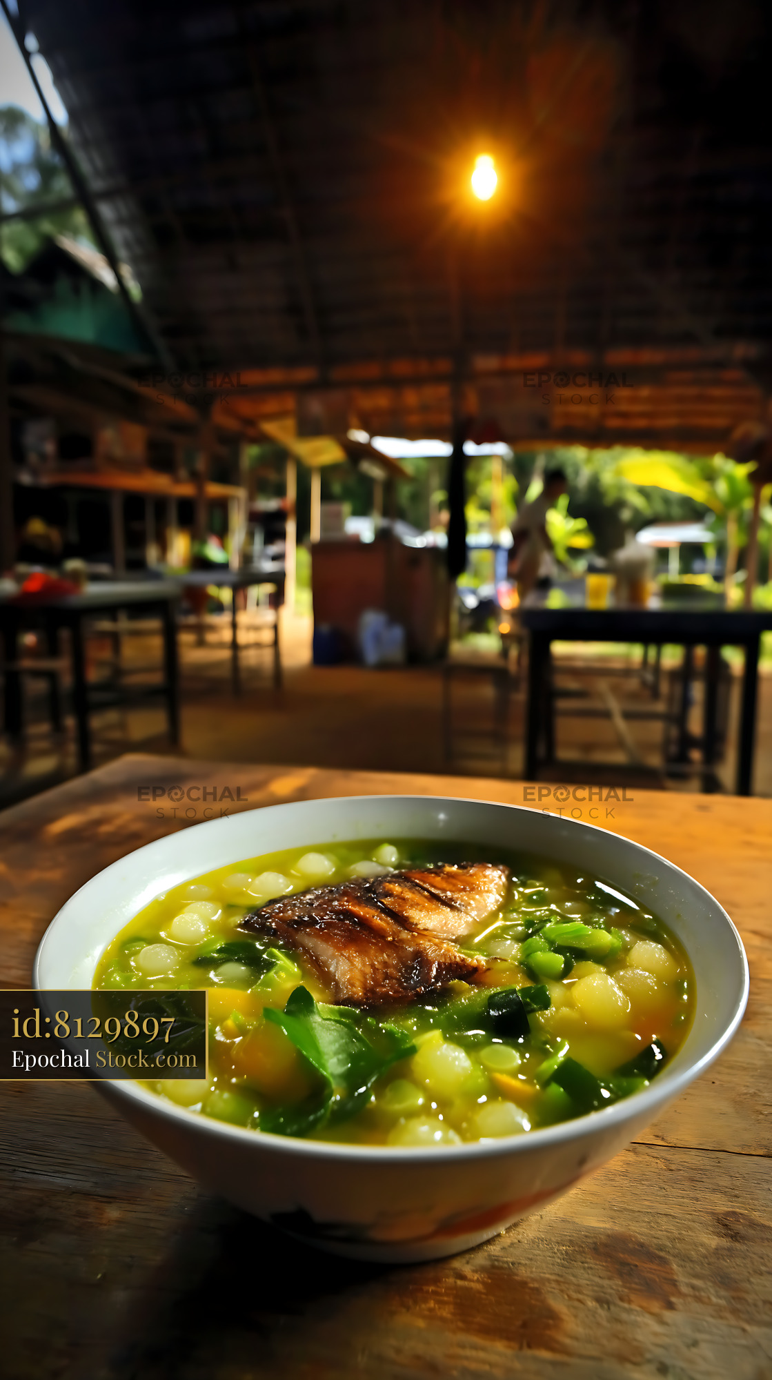 Hearty Lor Mee Soup with Grilled Fish in Rustic Setting - stock photo