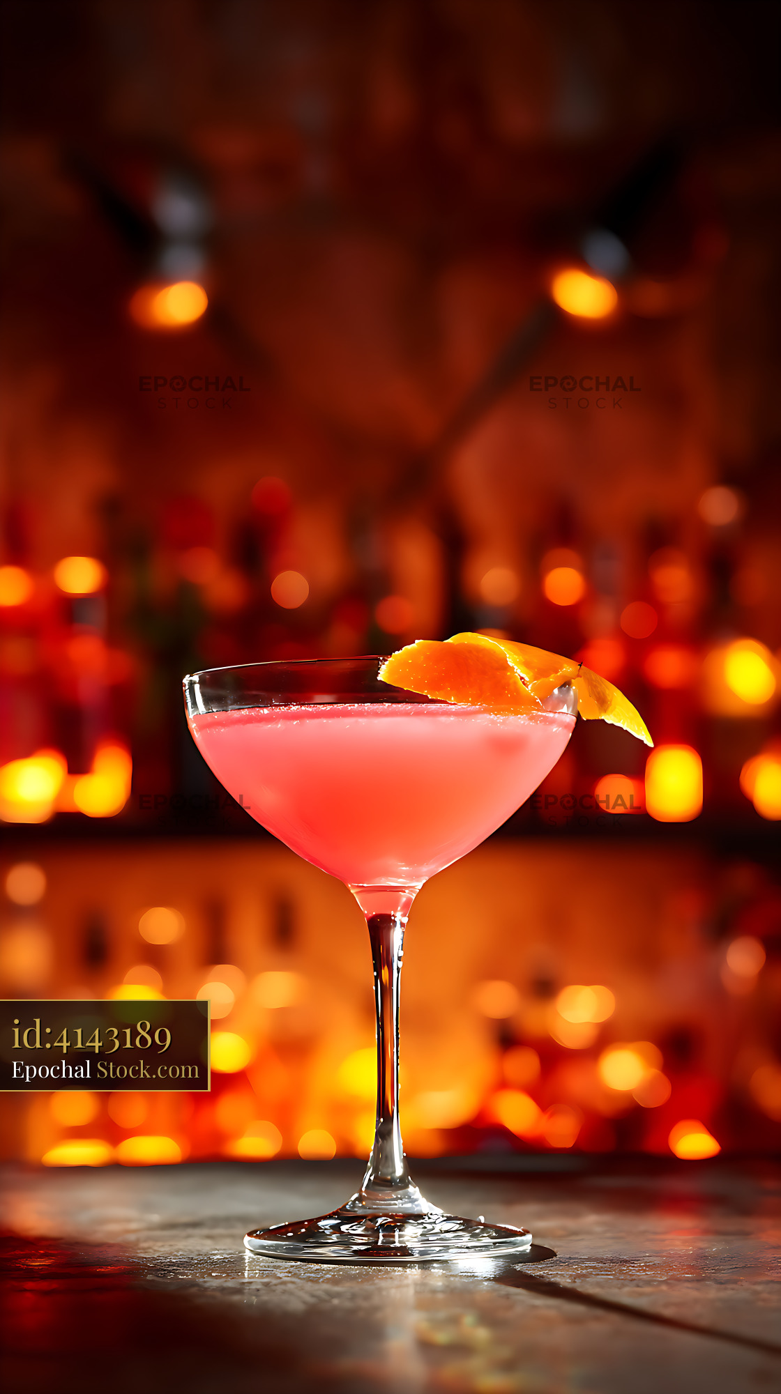 Pink Cocktail with Orange Peel on Bar Counter at Night - stock photo