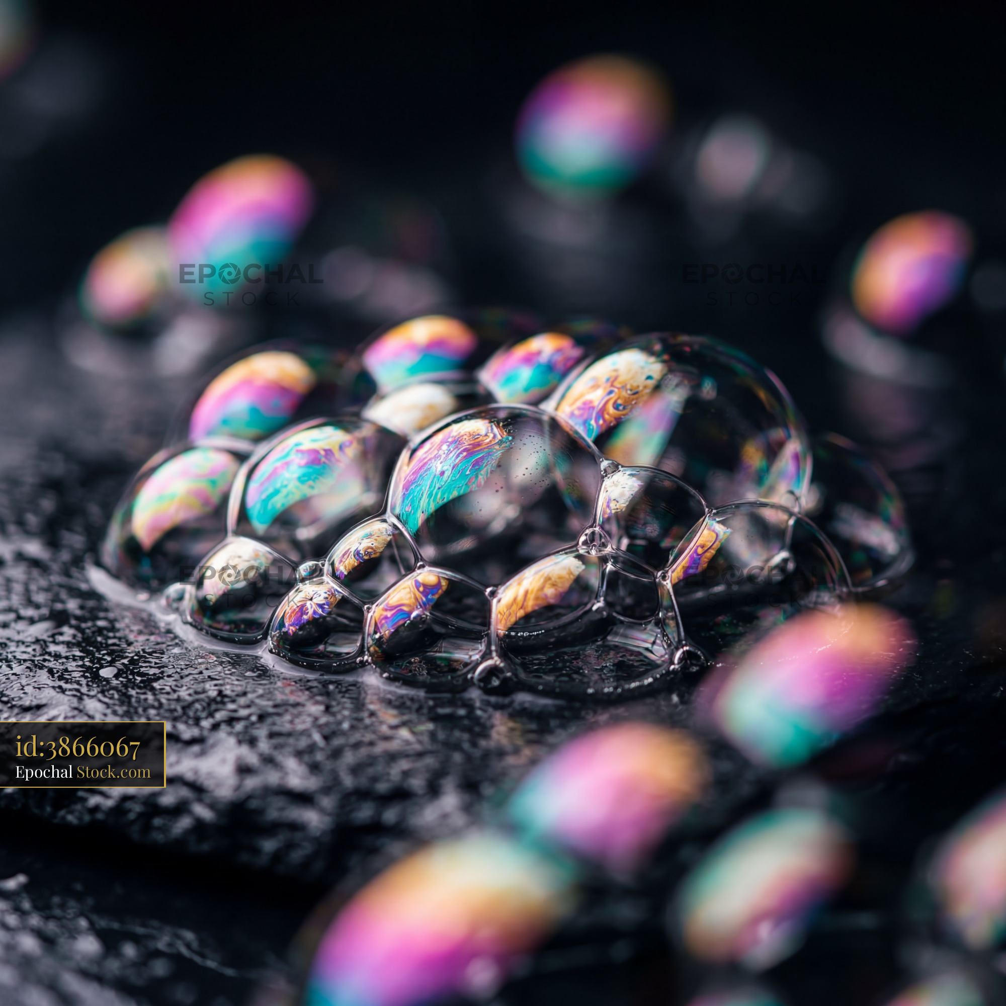 Colorful soap bubbles on a dark surface in close-up view Premium Stock Image