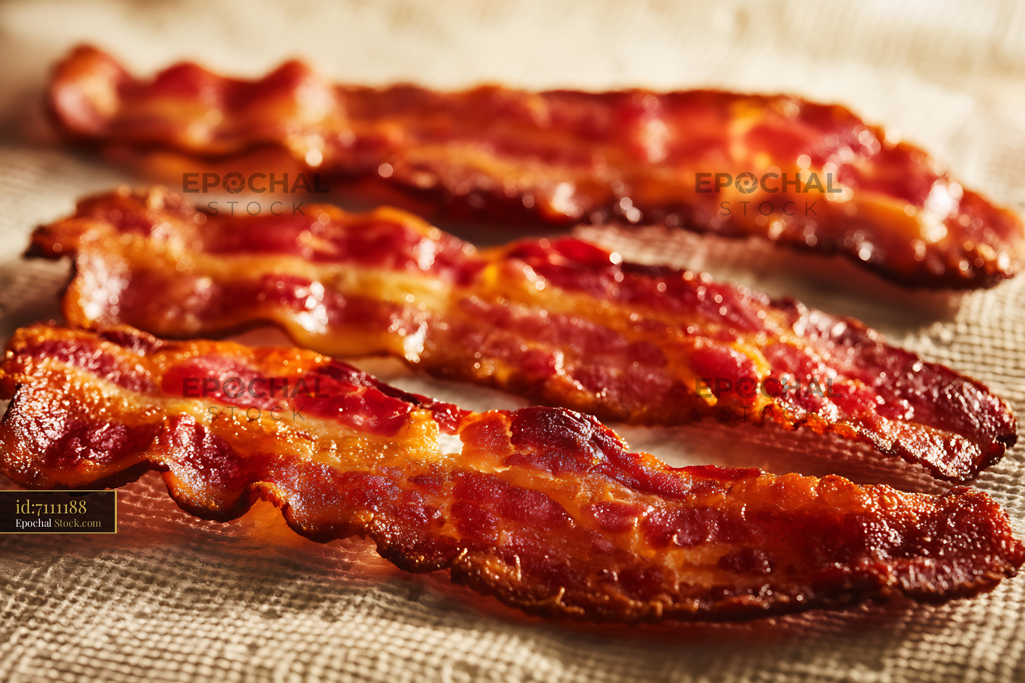 Crispy Bacon Strips on Parchment Paper - stock photo