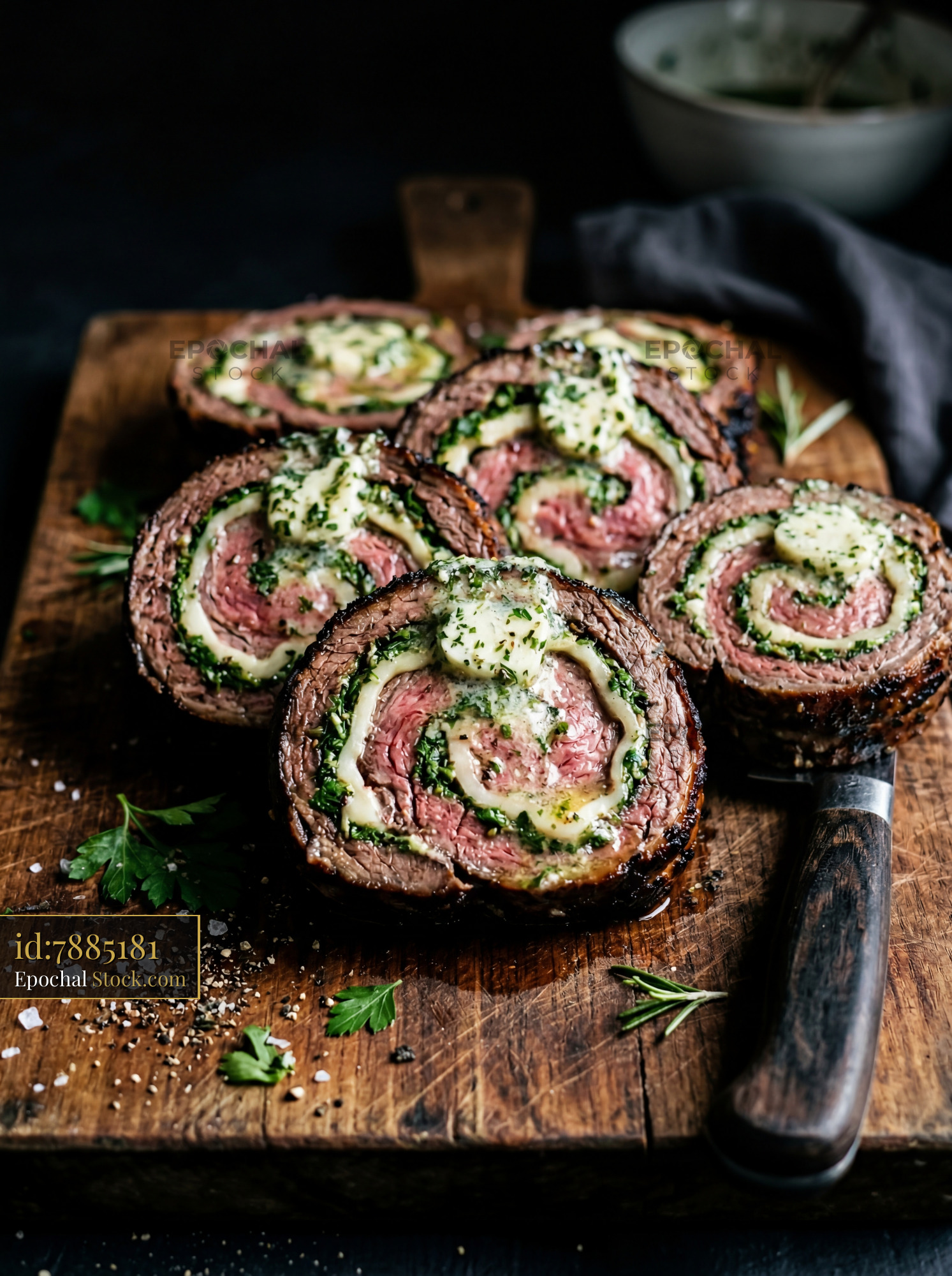 Herb-Stuffed Beef Roulade Sliced on Board - stock photo