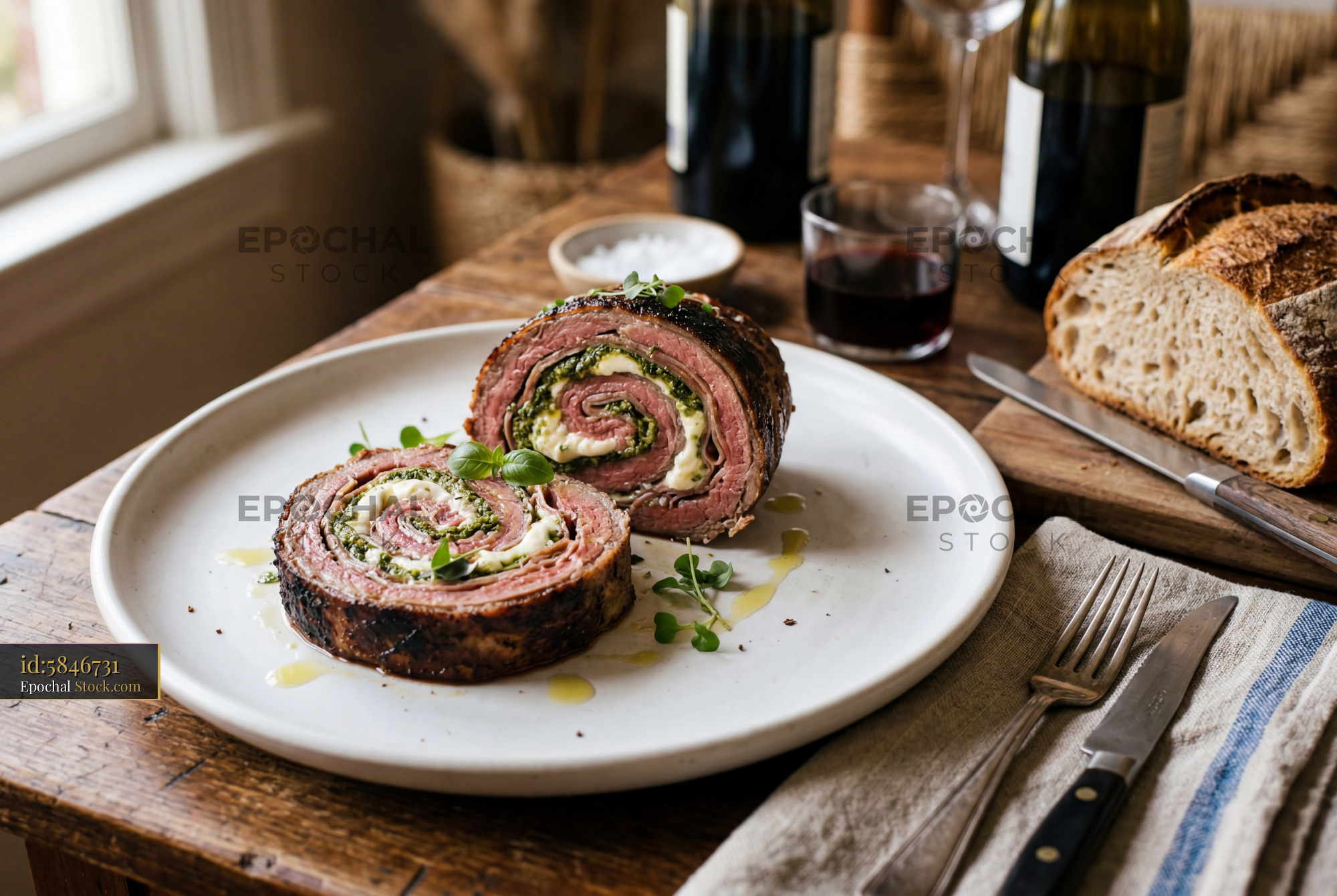 Beef Roulade with Spinach Garnish on White Plate - stock photo
