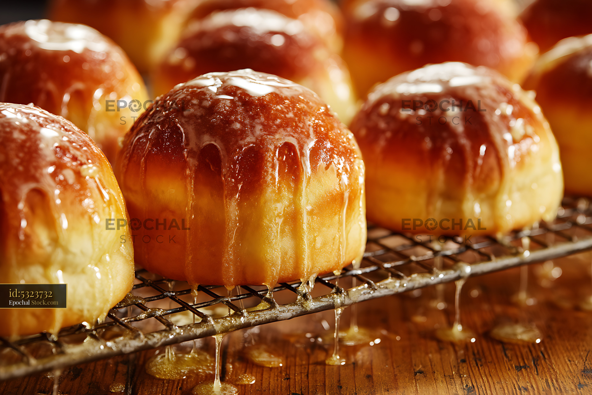 Fresh Glazed Pastries Dripping on Cooling Rack - stock photo