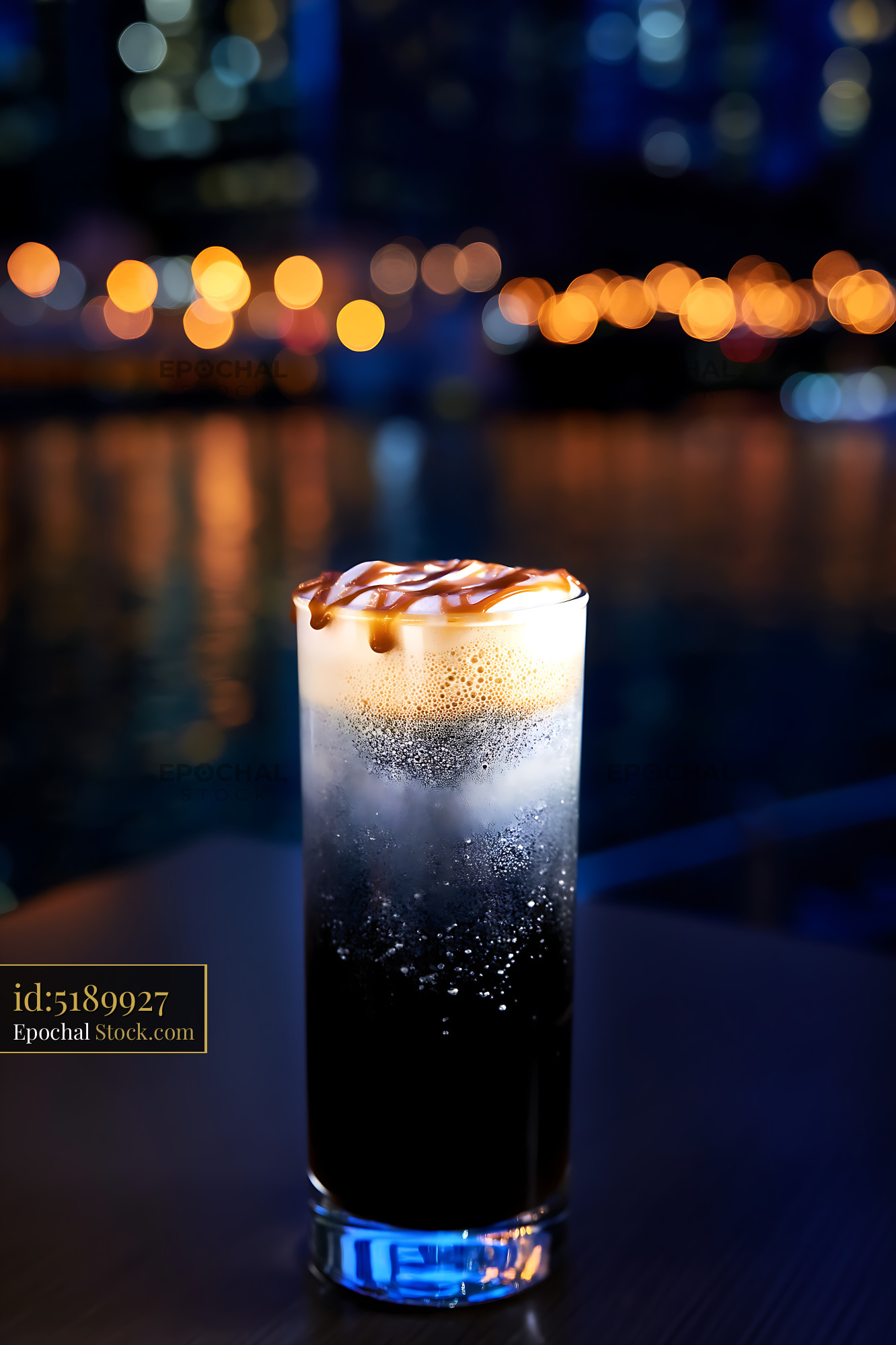 Nitro Caramel Coffee with Drizzle, Night City Backdrop - stock photo