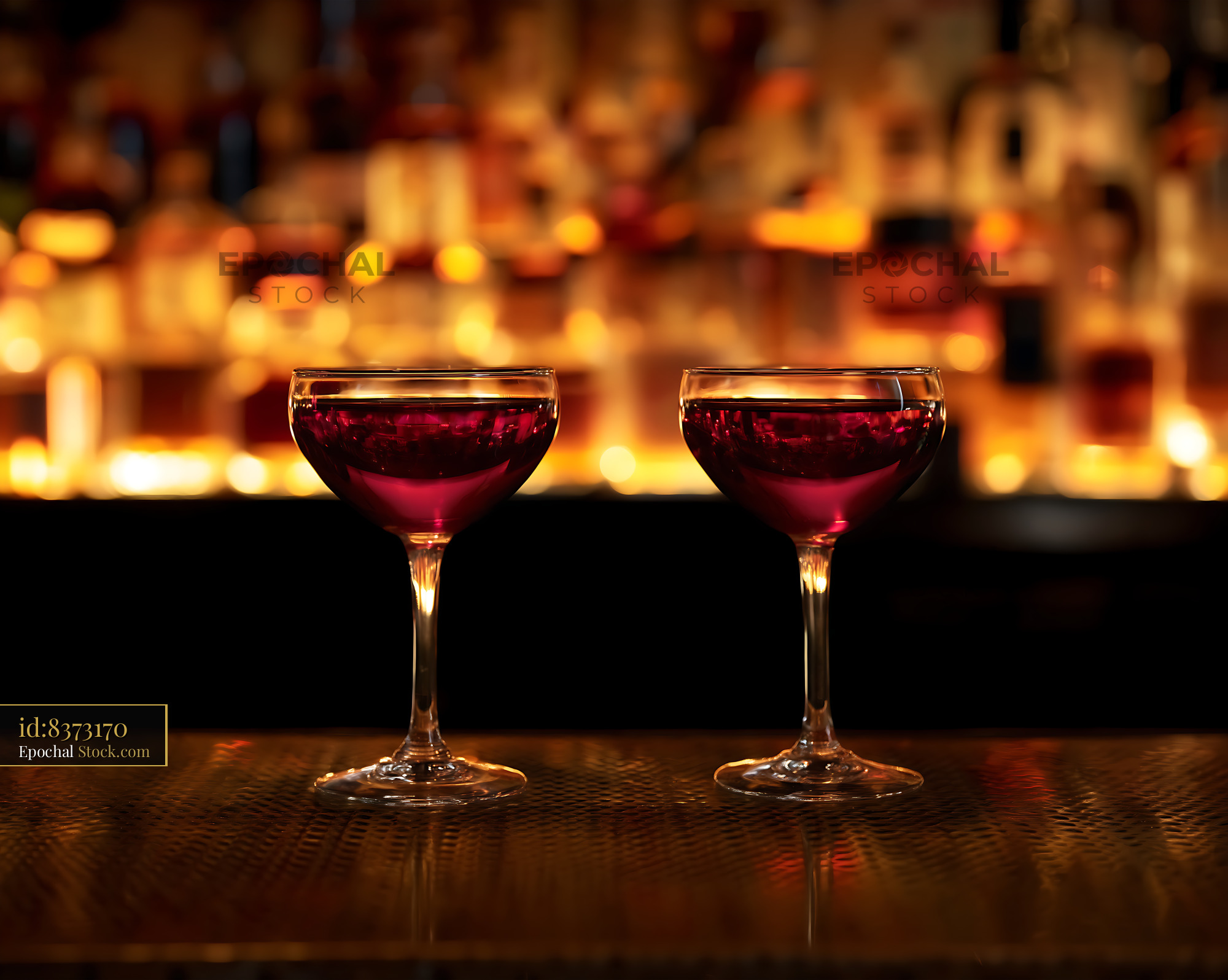 Bushwick Cocktails on Candlelit Bar Counter - stock photo