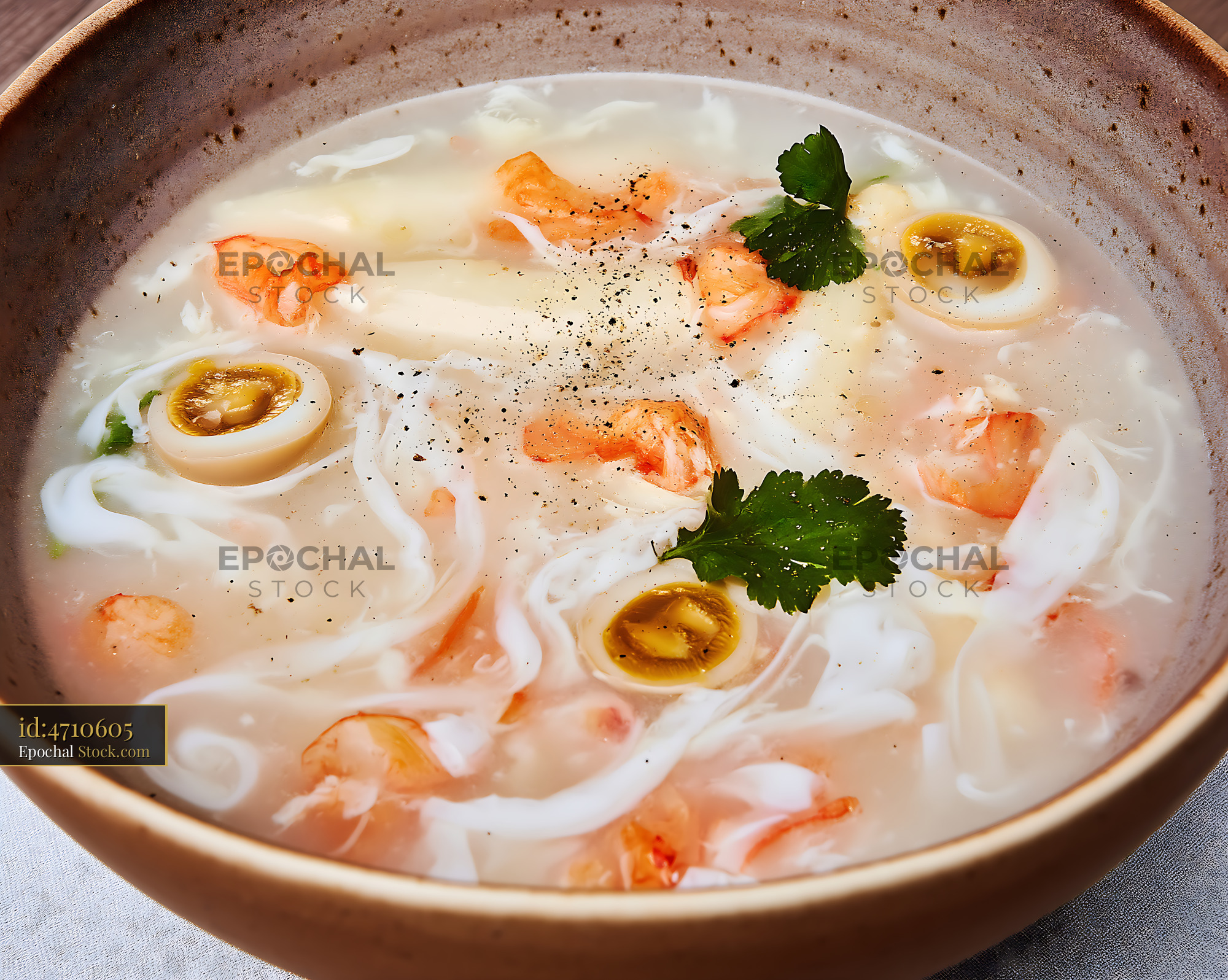 Sup Mang Cua Soup with Shrimp and Quail Eggs in Rustic Bowl - stock photo