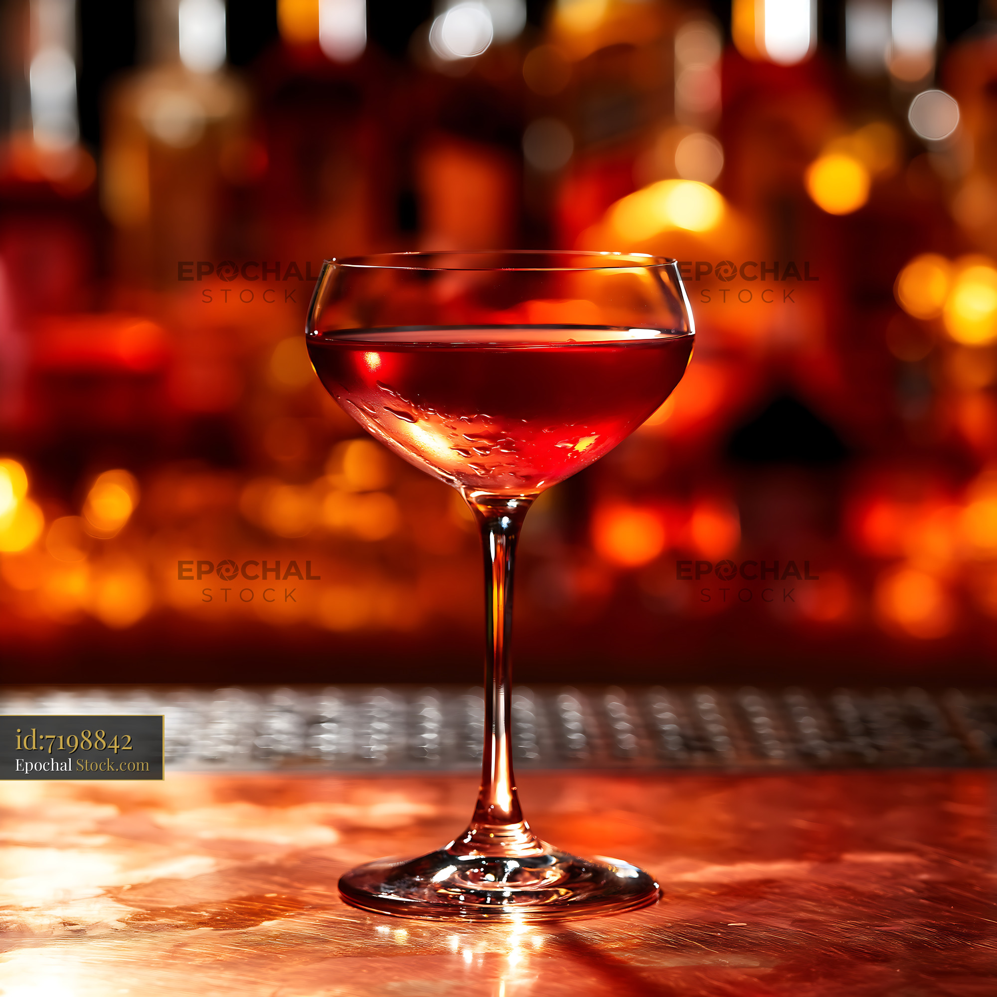 Bushwick Cocktail in Coupe Glass with Warm Bar Lighting - stock photo