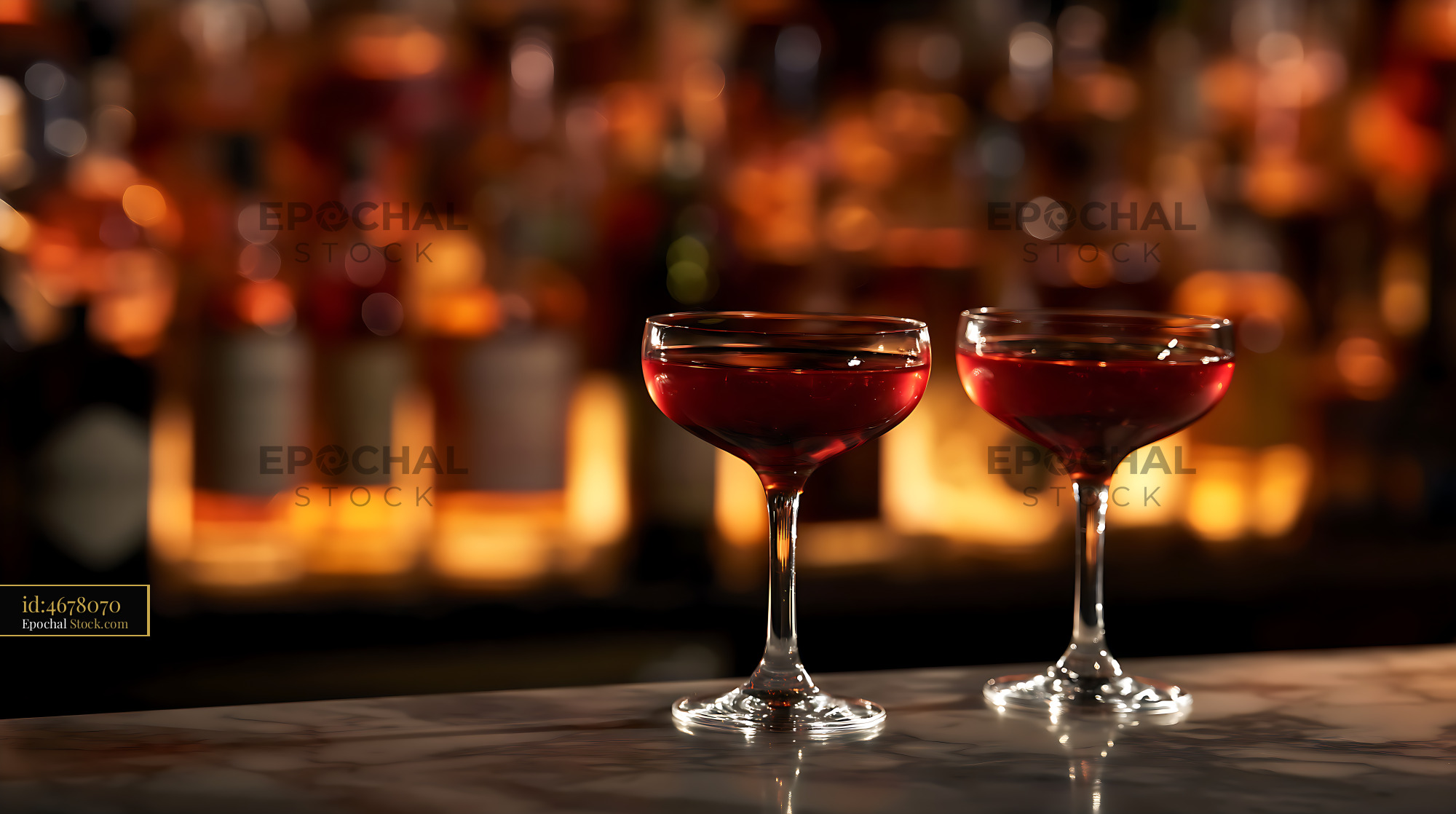 Red Cocktails in Coupe Glasses at Upscale Bar - stock photo